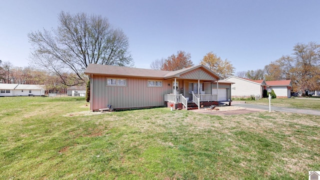 111 Honeysuckle Ln, Murray, KY 42071 - ranch-style house with a porch, driveway, an attached garage, board and batten siding, and a front lawn