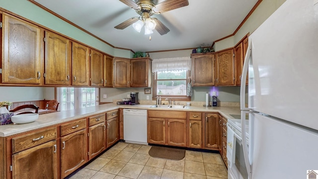 111 Honeysuckle Ln, Murray, KY 42071 - kitchen with white appliances, a sink, brown cabinets, crown molding, and healthy amount of natural light