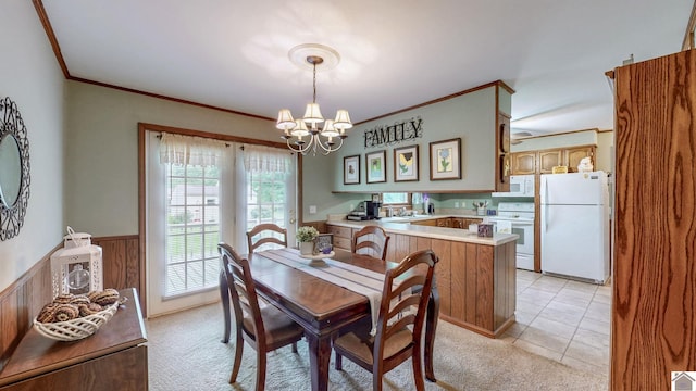 111 Honeysuckle Ln, Murray, KY 42071 - dining space with a chandelier, wainscoting, crown molding, light colored carpet, and light tile patterned floors