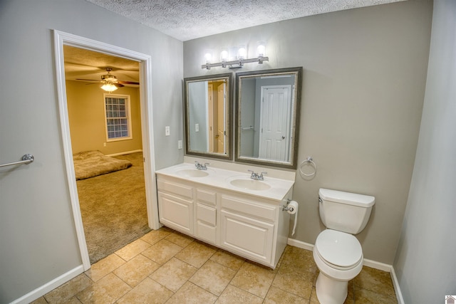 5904 Moors Camp Hwy, Gilbertsville, KY 42044 - bathroom with toilet, a textured ceiling, double vanity, and baseboards