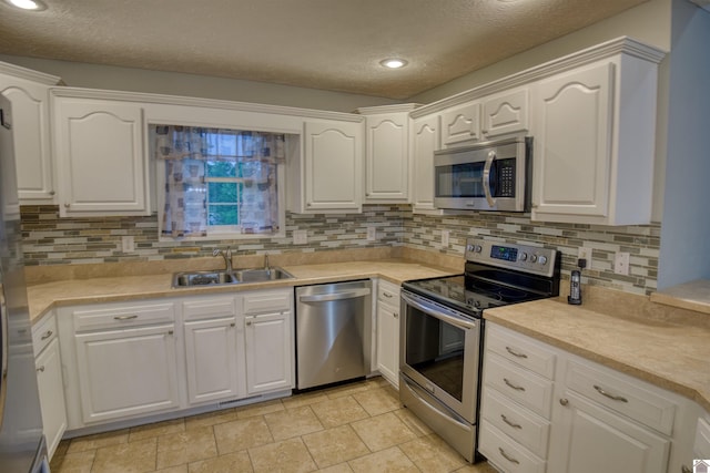 5904 Moors Camp Hwy, Gilbertsville, KY 42044 - kitchen featuring stainless steel appliances, a sink, a textured ceiling, white cabinets, and recessed lighting