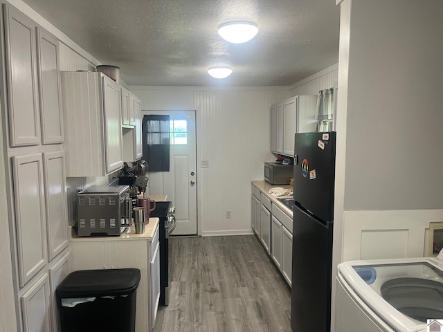 1903 State Route 564, Mayfield, KY 42066 - kitchen with freestanding refrigerator, a textured ceiling, light countertops, wood finished floors, and electric range oven