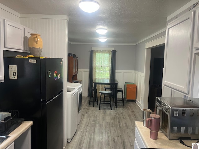 1903 State Route 564, Mayfield, KY 42066 - kitchen with independent washer and dryer, freestanding refrigerator, light wood finished floors, crown molding, and light countertops