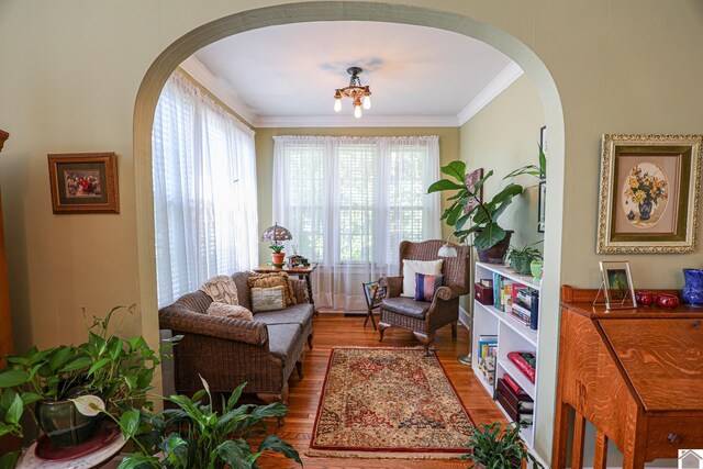 1931 Jefferson St, Paducah, KY 42001 - sitting room featuring arched walkways, wood finished floors, and crown molding