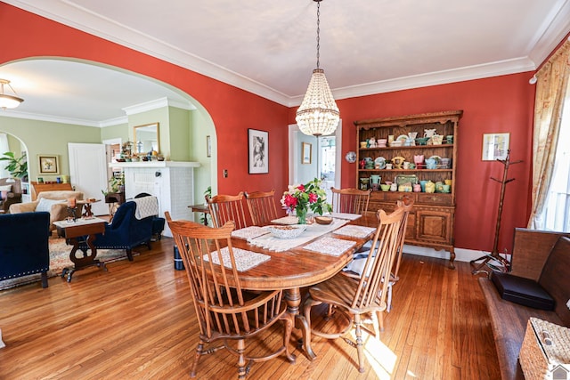 1931 Jefferson St, Paducah, KY 42001 - dining room featuring arched walkways, hardwood / wood-style flooring, crown molding, and a chandelier