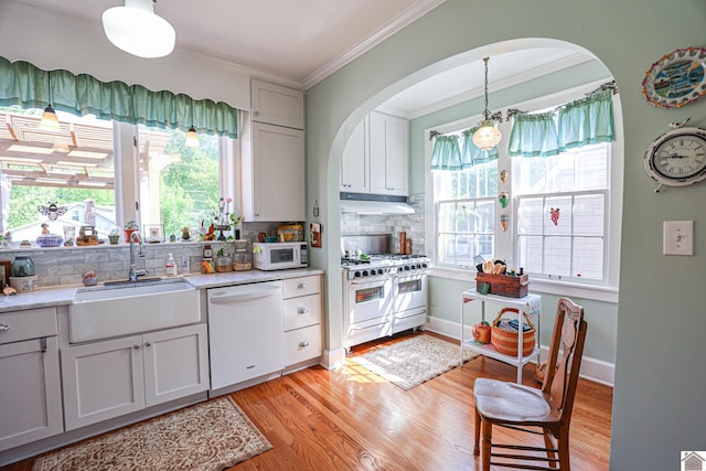 1931 Jefferson St, Paducah, KY 42001 - kitchen with white appliances, a sink, under cabinet range hood, crown molding, and backsplash