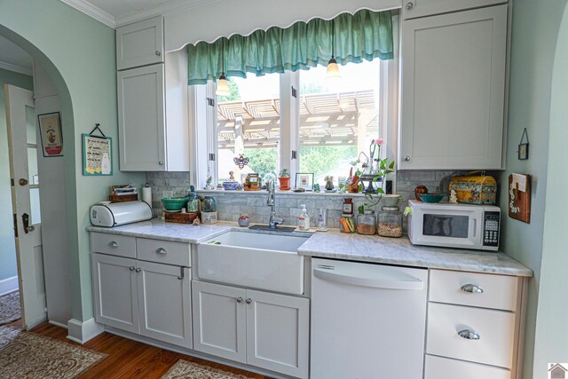 1931 Jefferson St, Paducah, KY 42001 - kitchen with white appliances, a sink, crown molding, wood finished floors, and tasteful backsplash