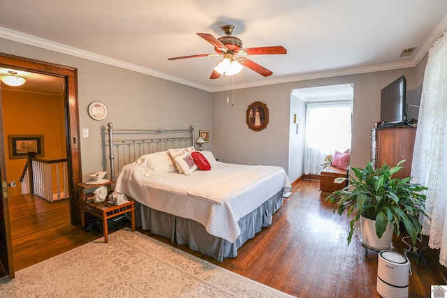 1931 Jefferson St, Paducah, KY 42001 - bedroom with wood finished floors, ornamental molding, baseboards, and a ceiling fan