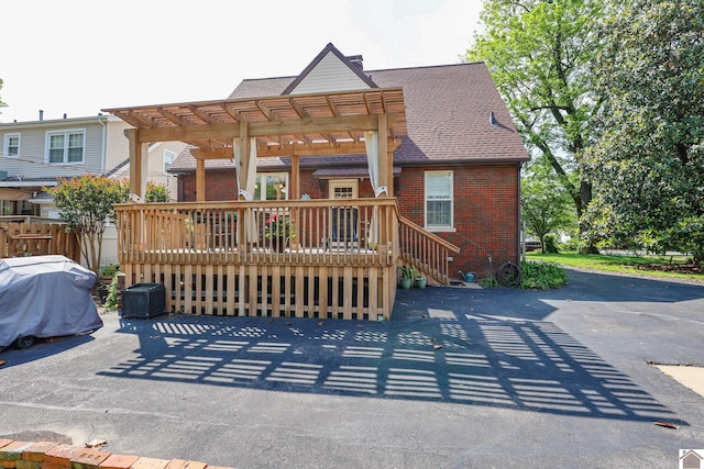 1931 Jefferson St, Paducah, KY 42001 - rear view of house with brick siding, a pergola, a shingled roof, and a wooden deck