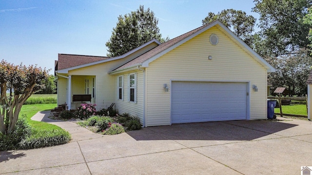 200 Lions Den Ln, Paducah, KY 42003 - view of side of home with driveway, a shingled roof, and an attached garage