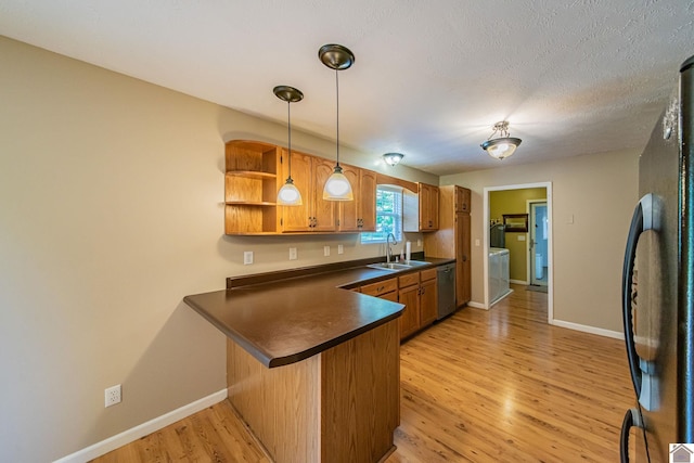 200 Lions Den Ln, Paducah, KY 42003 - kitchen featuring freestanding refrigerator, a sink, stainless steel dishwasher, dark countertops, and open shelves