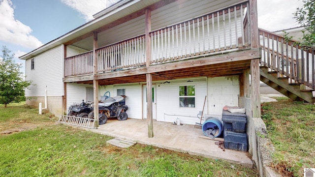 711 Rocky Rd, Fancy Farm, KY 42039 - rear view of house with a patio, a wooden deck, stairway, and a lawn