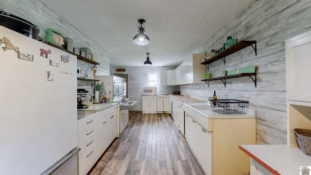 711 Rocky Rd, Fancy Farm, KY 42039 - kitchen featuring white appliances, open shelves, light countertops, white cabinets, and light wood-style flooring