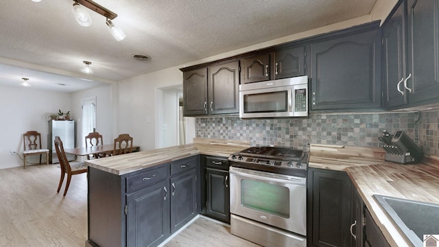 3500 Cairo, Paducah, KY 42001 - kitchen with stainless steel appliances, wooden counters, a peninsula, a textured ceiling, and light wood-style floors