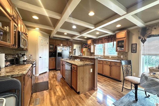5109 S Rd, Cadiz, KY 42211 - kitchen featuring stainless steel appliances, coffered ceiling, backsplash, wood finished floors, and brown cabinetry