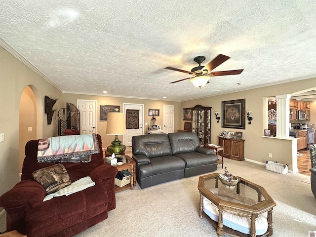 5109 S Rd, Cadiz, KY 42211 - living room featuring arched walkways, ceiling fan, carpet flooring, decorative columns, and a textured ceiling