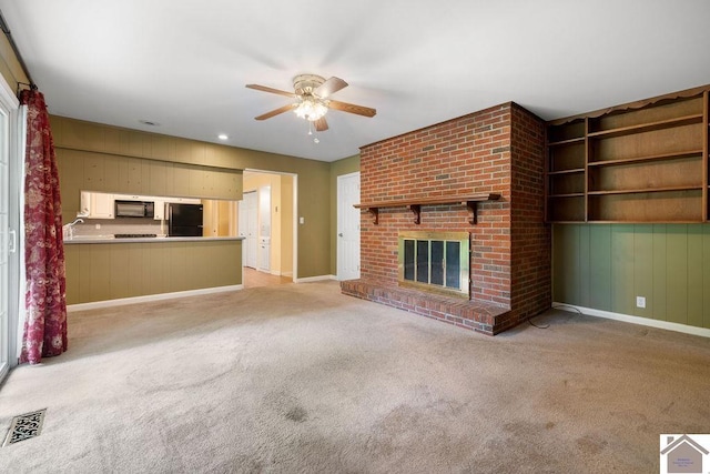 1906 Gatesborough Cir, Murray, KY 42071 - unfurnished living room with a ceiling fan, light carpet, a brick fireplace, and baseboards