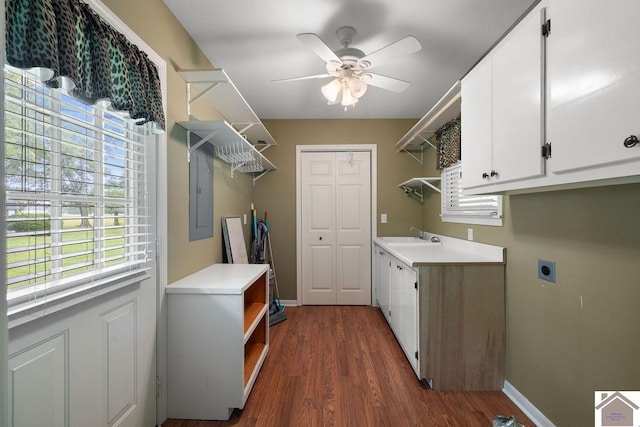 1906 Gatesborough Cir, Murray, KY 42071 - laundry area with cabinet space, electric dryer hookup, a ceiling fan, dark wood-style floors, and baseboards