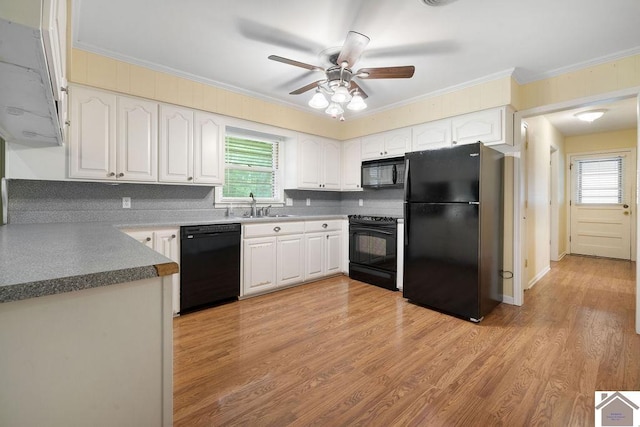 1906 Gatesborough Cir, Murray, KY 42071 - kitchen featuring black appliances, a sink, ornamental molding, plenty of natural light, and backsplash