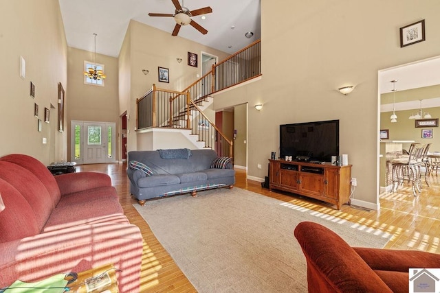 2007 Atkins Way, Murray, KY 42071 - living room with a towering ceiling, wood finished floors, a ceiling fan, stairway, and baseboards