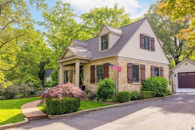 341 Friedman Ave, Paducah, KY 42001 - cape cod-style house with stone siding, a shingled roof, an outdoor structure, and a garage