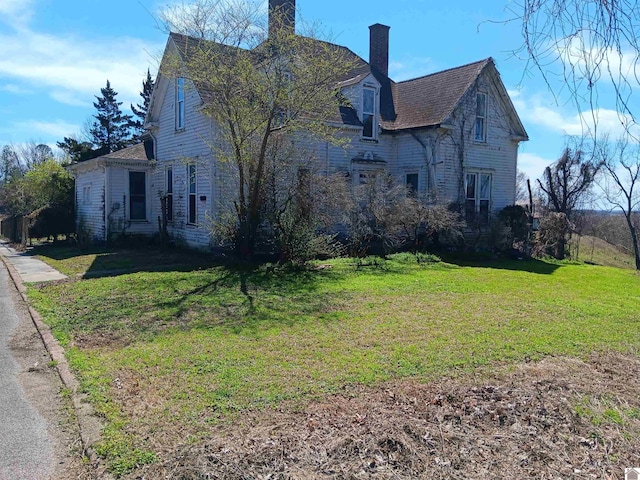 703 Fulton St, Hickman, KY 42050 - view of side of home with a chimney and a lawn