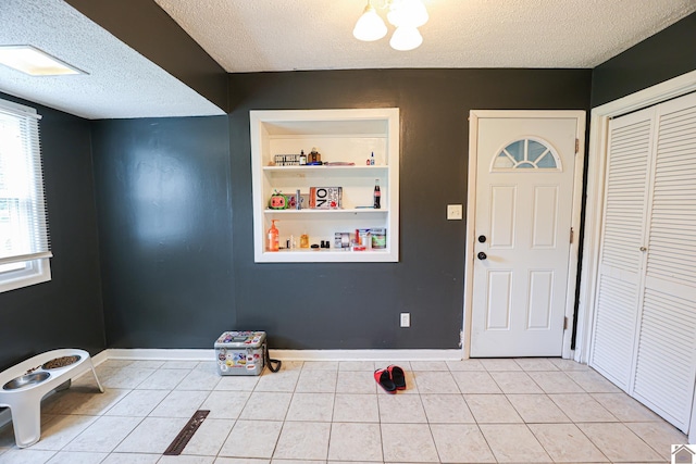 1124 Friedman Ln, Paducah, KY 42001 - entrance foyer with a textured ceiling, light tile patterned floors, and baseboards