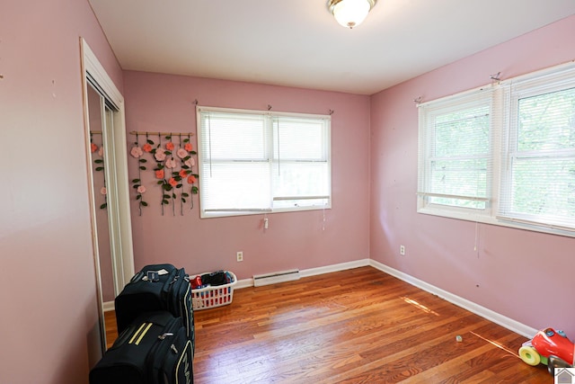 1124 Friedman Ln, Paducah, KY 42001 - unfurnished room featuring a baseboard heating unit, light wood finished floors, plenty of natural light, and baseboards