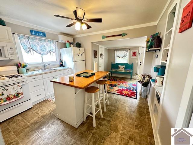 3944 Old Mayfield Rd, Paducah, KY 42003 - kitchen featuring white appliances, a sink, plenty of natural light, wood counters, and ornamental molding