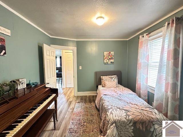 3944 Old Mayfield Rd, Paducah, KY 42003 - bedroom with ornamental molding, wood finished floors, and baseboards