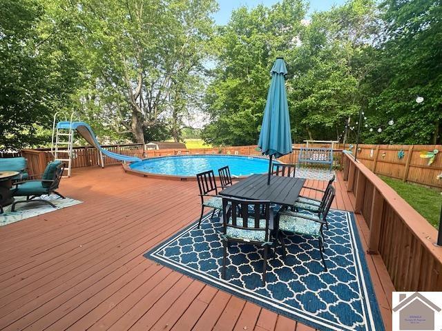 3944 Old Mayfield Rd, Paducah, KY 42003 - deck featuring outdoor dining space, fence, and view of wooded area