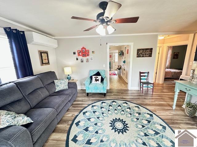 3944 Old Mayfield Rd, Paducah, KY 42003 - living room with wood finished floors, ornamental molding, baseboards, a wall mounted air conditioner, and a ceiling fan