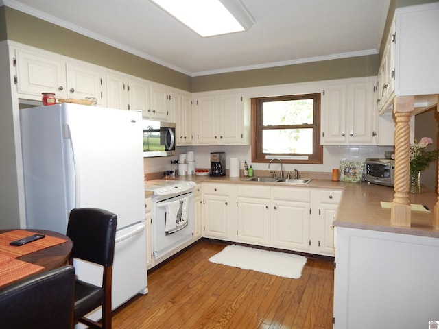 60 Cole Ln, Benton, KY 42025 - kitchen with white appliances, a sink, wood-type flooring, white cabinets, and crown molding