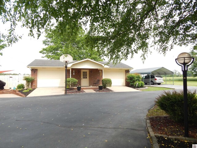 60 Cole Ln, Benton, KY 42025 - view of front of home with brick siding, an attached garage, and driveway