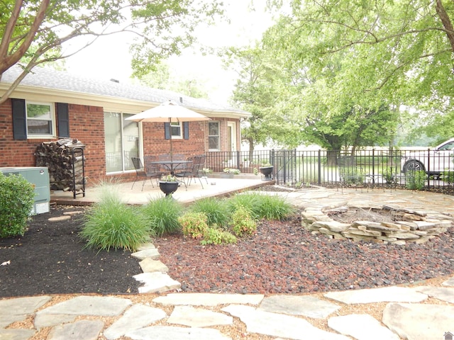 60 Cole Ln, Benton, KY 42025 - back of property featuring brick siding, fence, a fire pit, and a patio