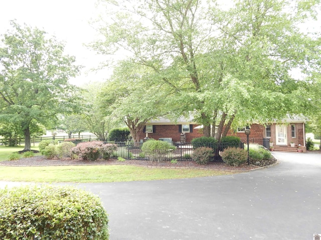 60 Cole Ln, Benton, KY 42025 - view of front facade with brick siding, asphalt driveway, and a fenced front yard