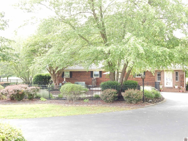 60 Cole Ln, Benton, KY 42025 - view of front of property with brick siding, a fenced front yard, and driveway
