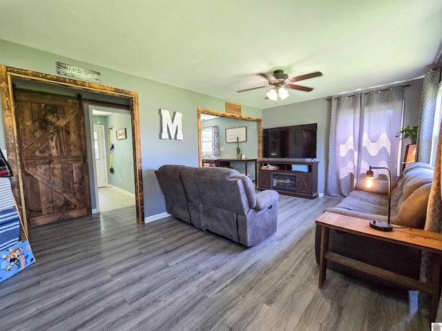 2230 Seneca Ln, Paducah, KY 42001 - living area featuring a ceiling fan, wood finished floors, a barn door, and baseboards