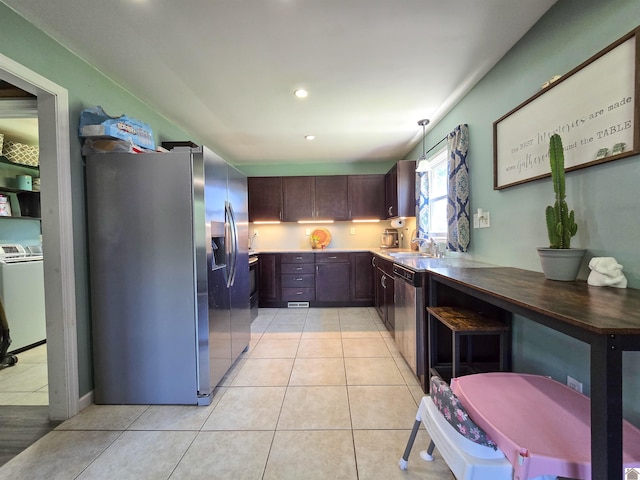 2230 Seneca Ln, Paducah, KY 42001 - kitchen with stainless steel appliances, a sink, washer / dryer, light tile patterned floors, and recessed lighting