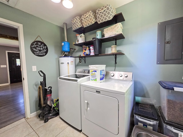 2230 Seneca Ln, Paducah, KY 42001 - washroom featuring electric panel, washing machine and dryer, water heater, light tile patterned floors, and baseboards