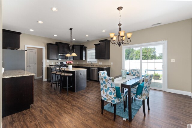 115 Pinewood Trl, West Paducah, KY 42086 - dining area with a chandelier, dark wood finished floors, recessed lighting, and baseboards