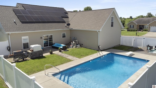 115 Pinewood Trl, West Paducah, KY 42086 - back of house featuring solar panels, an outdoor hangout area, a shingled roof, a patio area, and a gate