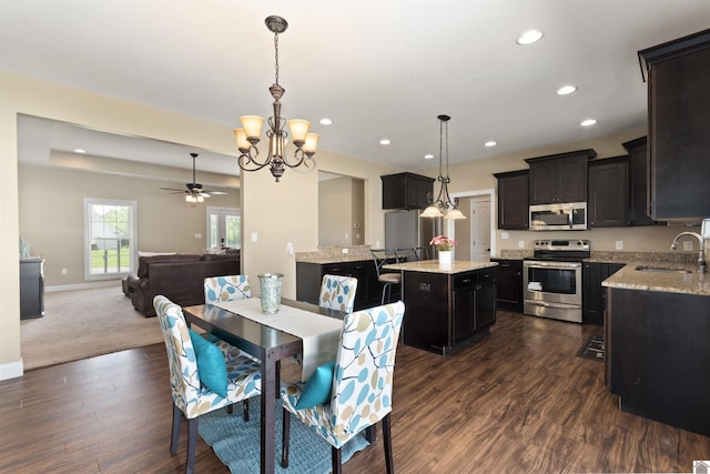 115 Pinewood Trl, West Paducah, KY 42086 - dining room with recessed lighting, dark wood-style floors, a chandelier, ceiling fan, and baseboards
