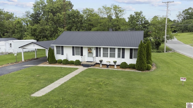 103 Leland Ave, Marion, KY 42064 - ranch-style home with a front yard, driveway, and metal roof