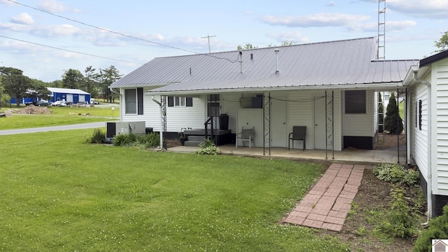 103 Leland Ave, Marion, KY 42064 - rear view of property with a lawn, central AC unit, a patio, and metal roof