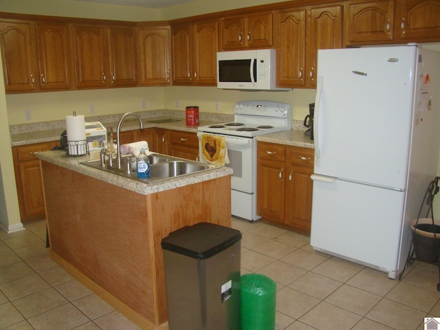 115 Meadowbrook Dr, Cadiz, KY 42211 - kitchen with white appliances, light tile patterned flooring, a kitchen island with sink, brown cabinets, and light countertops