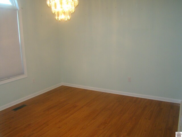 115 Meadowbrook Dr, Cadiz, KY 42211 - spare room with a chandelier and wood finished floors