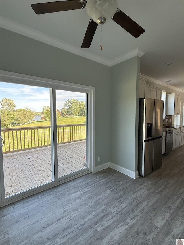 631 Imogene Dr, Gilbertsville, KY 42044 - unfurnished living room featuring ceiling fan, crown molding, dark wood finished floors, baseboards, and a sink