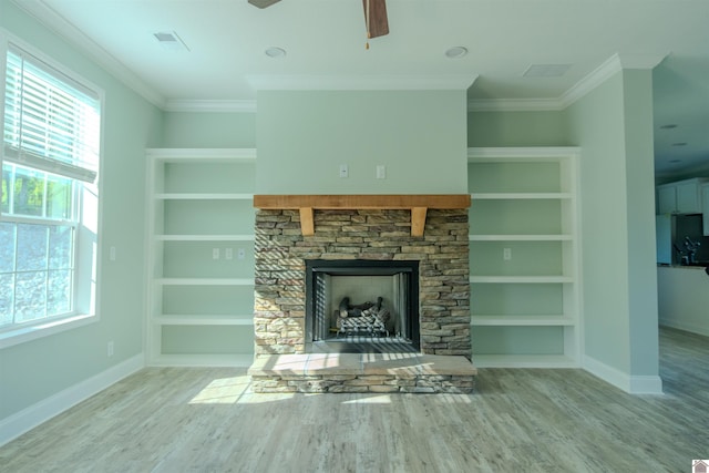 631 Imogene Dr, Gilbertsville, KY 42044 - unfurnished living room featuring baseboards, wood finished floors, crown molding, ceiling fan, and built in shelves
