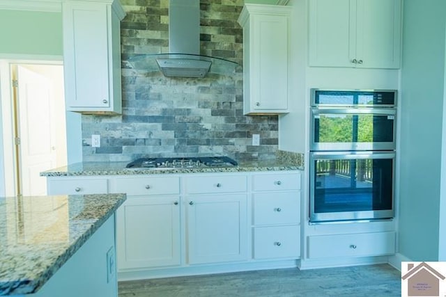 631 Imogene Dr, Gilbertsville, KY 42044 - kitchen featuring stainless steel appliances, decorative backsplash, white cabinets, and light stone countertops